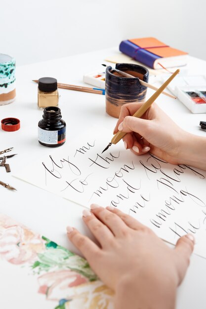 Girl writing calligraphy on postcards. Art design.