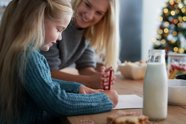 Free photo girl writing a letter to santa claus