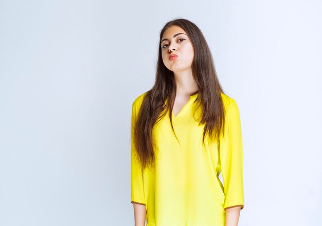 Girl in yellow shirt looks tired or has headache.