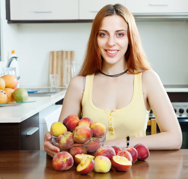 girl in yellow with peaches at home