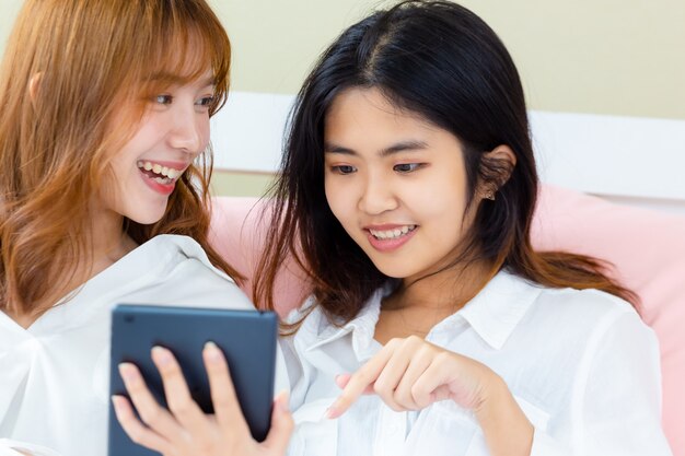 Girlfriend enjoy to use smartphone on the bed