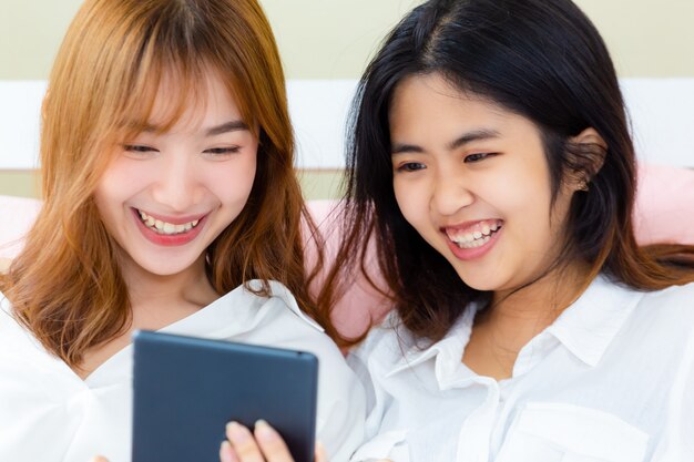 Girlfriend enjoy to use smartphone on the bed