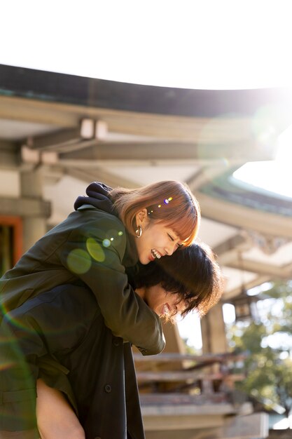 Girlfriend piggyback riding her boyfriend while on a date