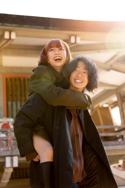 Girlfriend piggyback riding her boyfriend while on a date