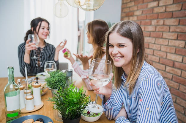 Girlfriends chatting and drinking wine