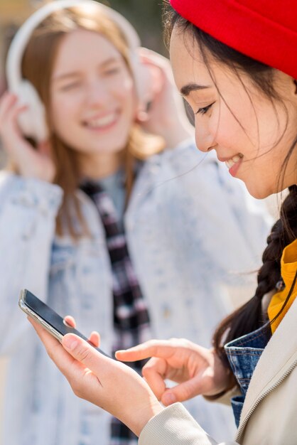 Girlfriends listening music outdoor