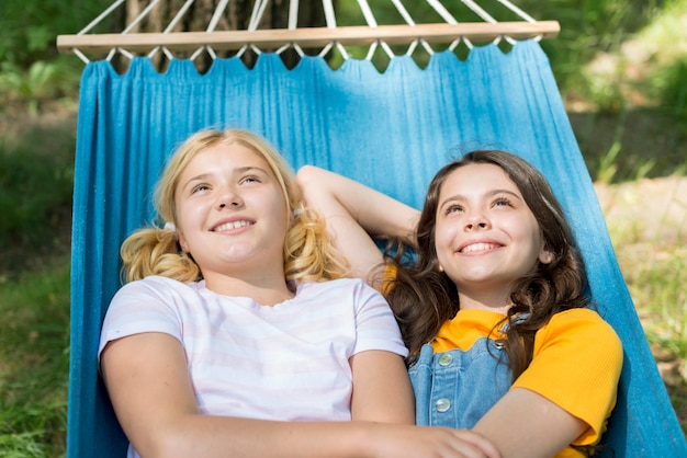 Girlfriends sitting in hammock
