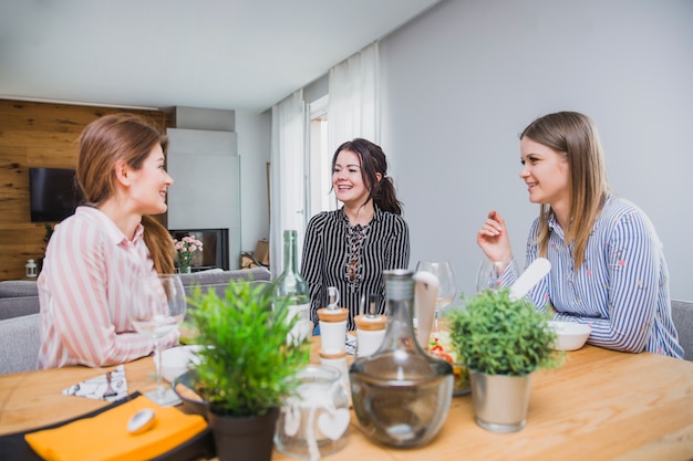 Girlfriends at table laughing and talking