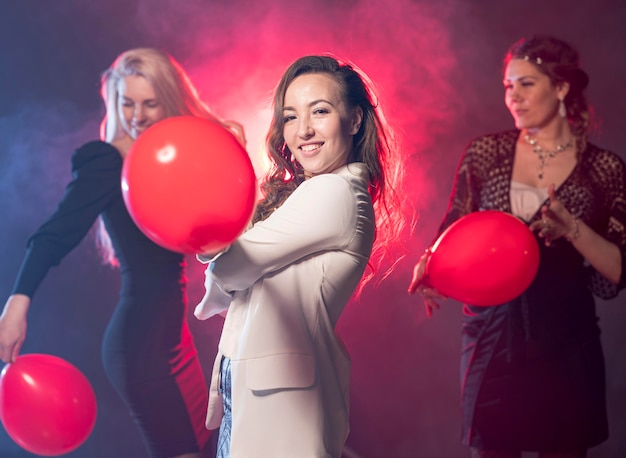 Girlfriends with balloons at party