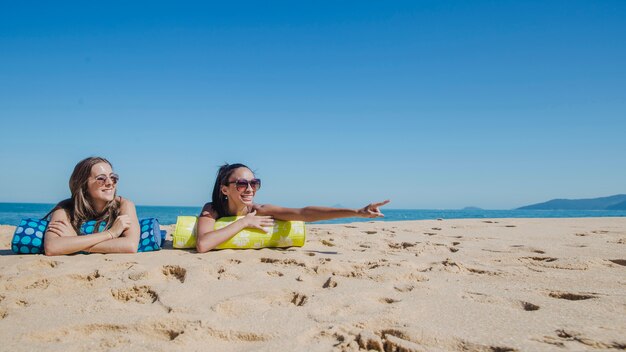 Girls at the beach looking somewhere