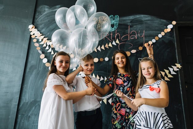 Girls and boy with balloons