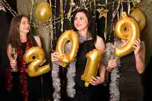 Free photo girls celebrating 2019 at new year party