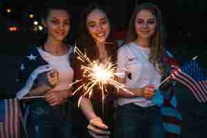 Free photo girls celebrating independence day with sparkler