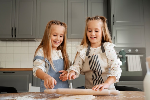 Free photo girls cooking together front view