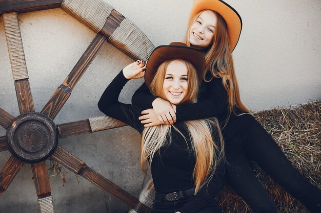Girls in a cowboys hat on a ranch