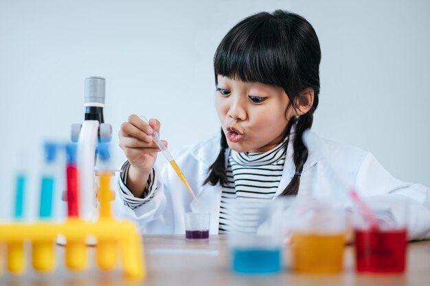 Girls doing science experiments in the lab. Selective focus.