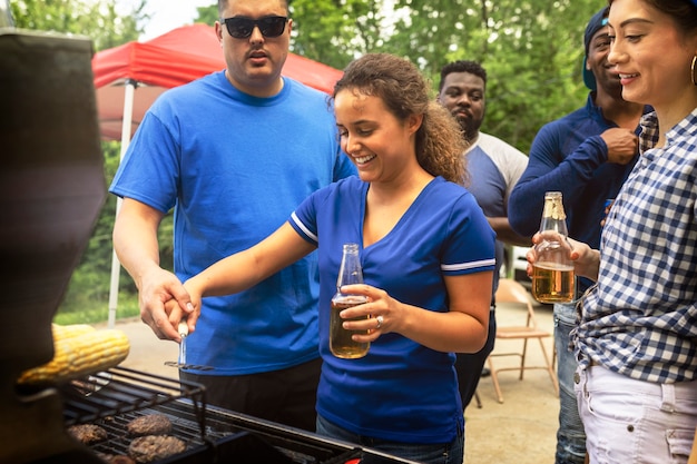 Girls grilling burgers at a tailgate party