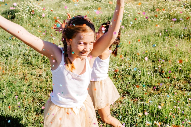 Free photo girls having fun under confetti shower