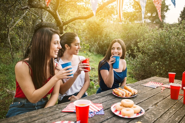 Girls having picnic on sunset