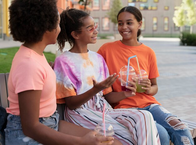 Girls holding drinks medium shot