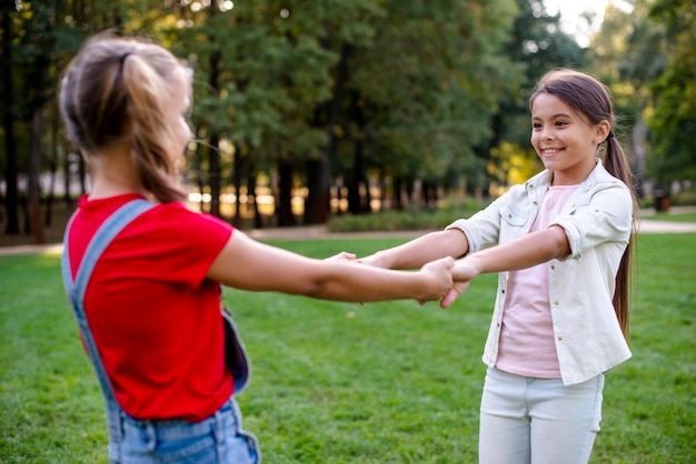 Girls holding hands outdoors