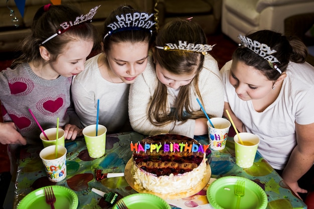 Free photo girls looking at birthday cake