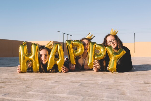 Girls lying behind happy writing