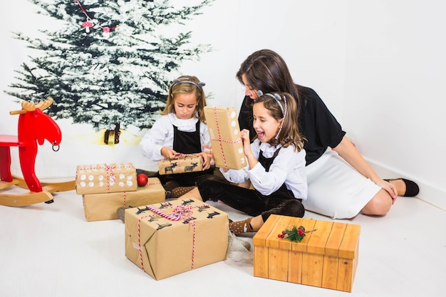 Girls and mother with gift boxes