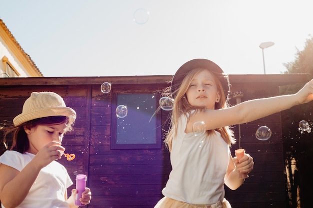 Free photo girls playing with bubbles