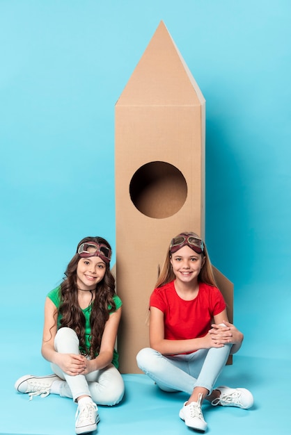 Free photo girls playing with cartoon airplane toy