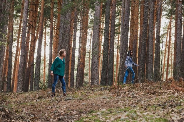 Girls playing with trees in the forest