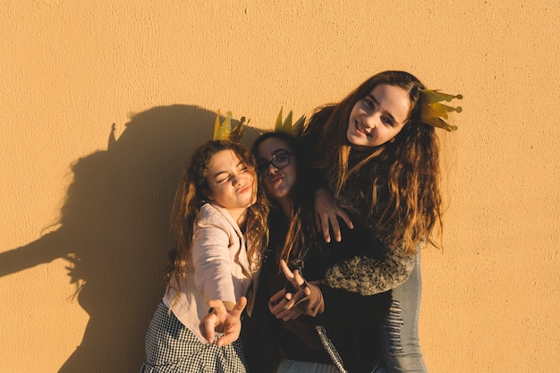 Girls posing near wall