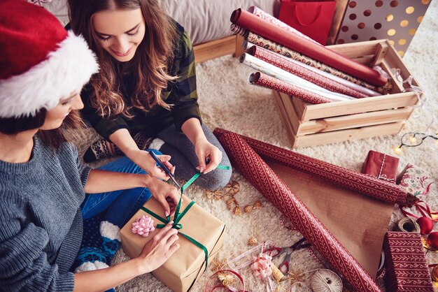 Girls  preparing a present for christmas