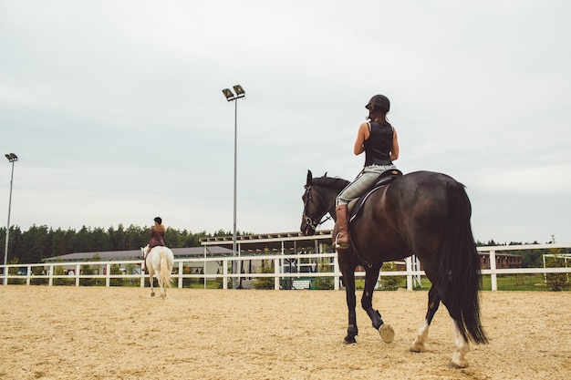 the girls ride on horses