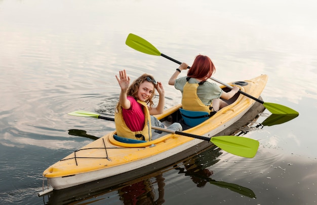 Free photo girls rowing in kayak