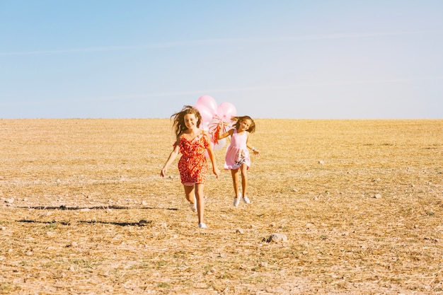 Free photo girls running with balloons