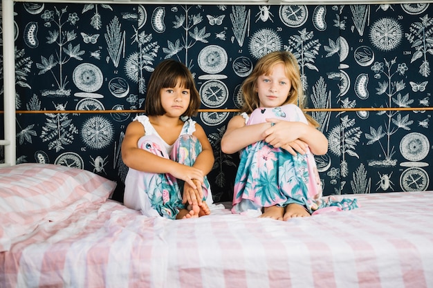 Girls sitting on bed