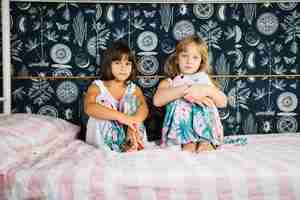 Free photo girls sitting on bed