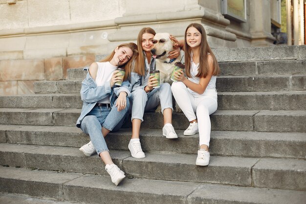 Girls sitting on a staircase with cute dog