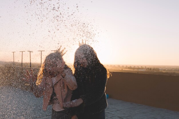 Girls under splashes of foam