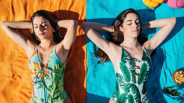 Girls taking sunbath at the beach