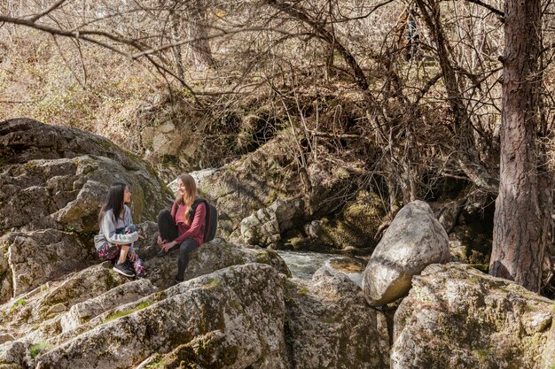 Girls talking by a river