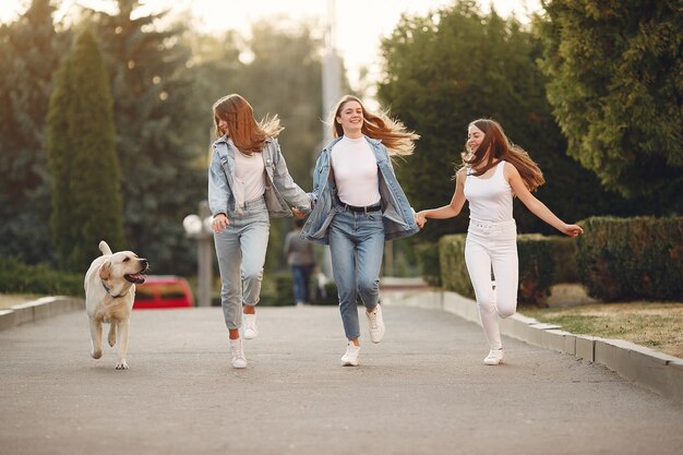 Girls walking in a spring city with cute dog