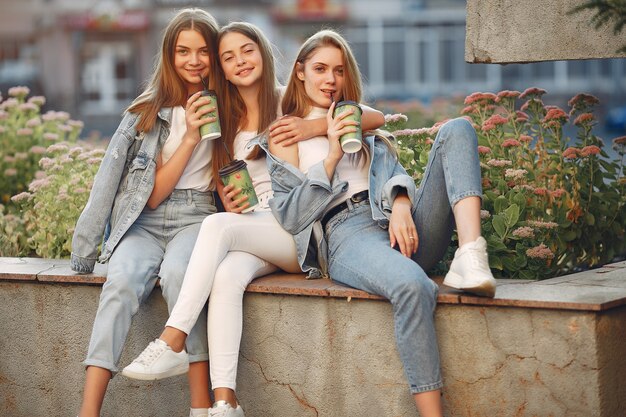 Free photo girls walking in a spring sity and hold coffee in her hand