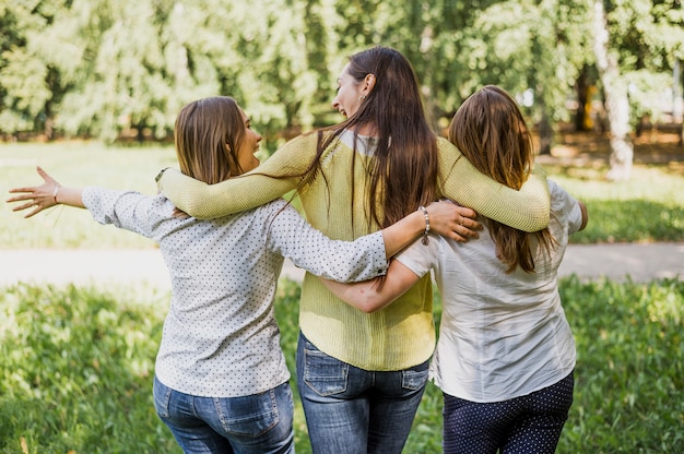 Girls walking while hugging each other