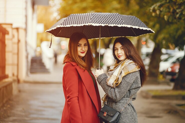 Free Photo girls walks. women with umbrella. lady in a coat.