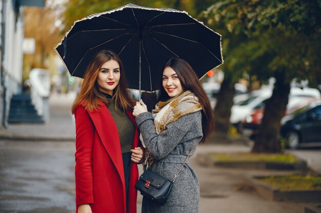 Girls walks. Women with umbrella. Lady in a coat.