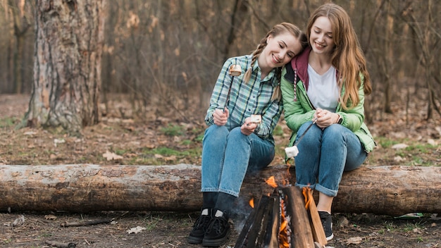 Girls warming at bonfire