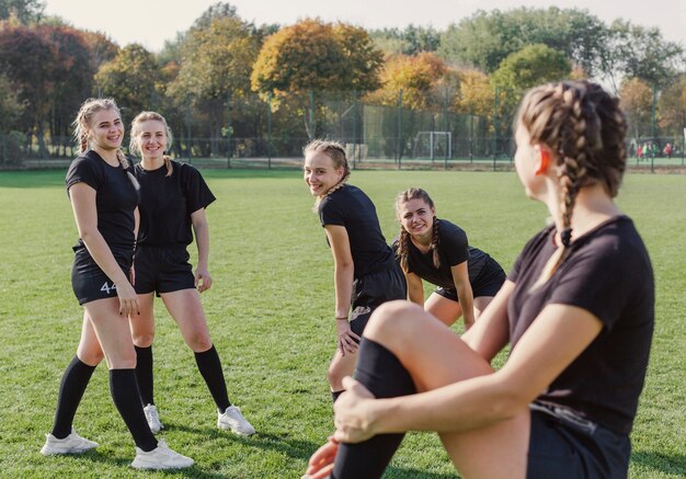 Girls warming up on football field