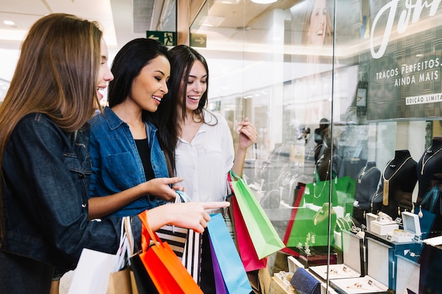 Free photo girls watching display of store